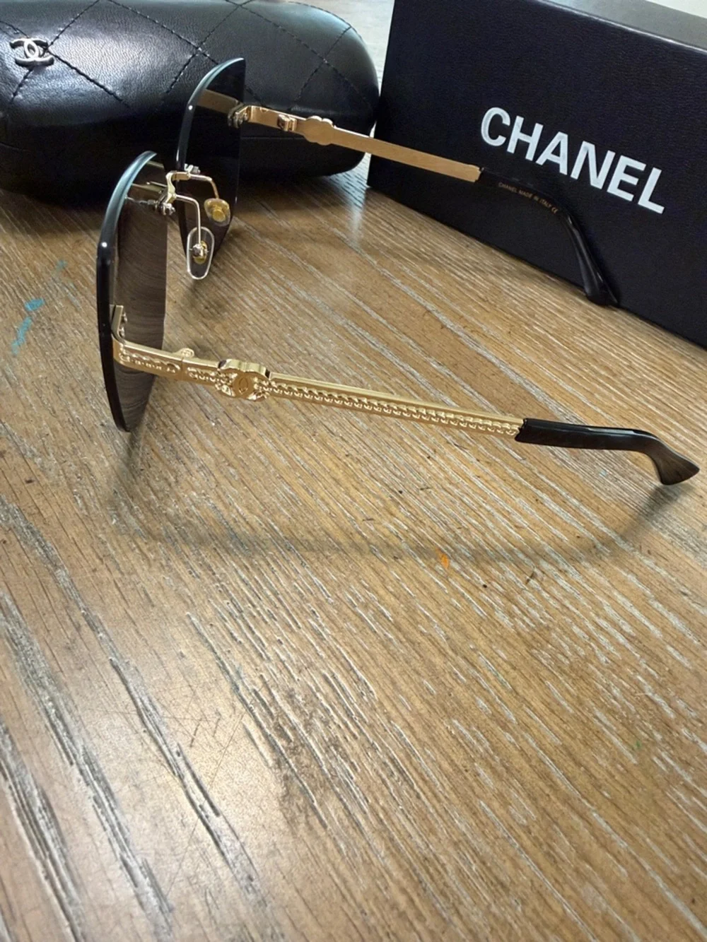 Chanel Women's Black and Gold Rimless Square Sunglasses